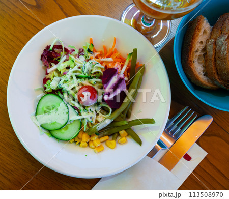 Salad of corn, cucumbers, cabbage and boiled bean with carrot 113508970