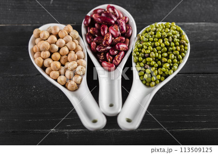 mix of beans on wooden table 113509125