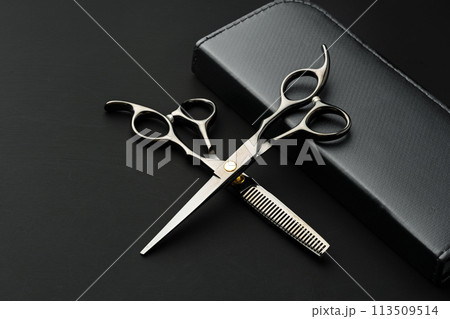 Hairdressing scissors with case on a black background Hairdressing scissors with case on a black background 113509514