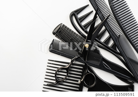 Black hairdressing tools and various hairbrushes on white background 113509591