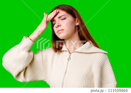 A woman is seen sitting with her head buried in her hands, appearing distressed or overwhelmed. 113509868