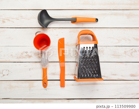 Various kitchen utensils on wooden table Various kitchen utensils on wooden table 113509980