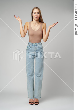 Clueless Young Woman Holding Out Her Hands Gesturing She Doesn't Know Clueless Young Woman Holding Out Her Hands Gesturing She Doesn't Know 113509985