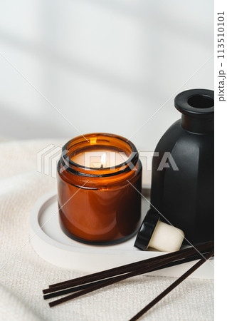 Elegant Aroma Diffuser With Reed Sticks And Scented Candle On White Tablecloth 113510101