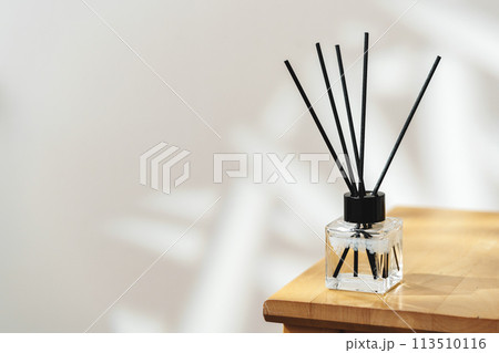 Modern Reed Diffuser on Wooden Table in Minimalist Interior During Daytime 113510116