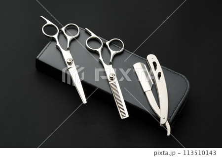 Hairdressing scissors with case on a black background 113510143