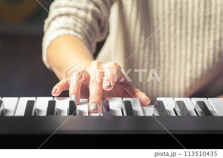Closeup of hands playing piano. Music and hobby concept 113510435
