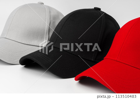 Lineup of Four Blank Baseball Caps in Red, White, and Black on a White Background Lineup of Four Blank Baseball Caps in Red, White, and Black on a White Background 113510483