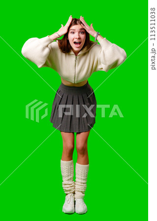 Young Woman Gesturing Excitement in Casual Attire Against Green Screen Backdrop 113511038
