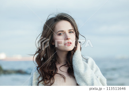 Cute brunette woman with fresh skin, natural make-up and healthy wavy brown hair Cute brunette woman with fresh skin, natural make-up and healthy wavy brown hair 113511646