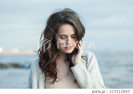 Outdoor portrait of young woman model with brown hair and natural make-up Outdoor portrait of young woman model with brown hair and natural make-up 113511647