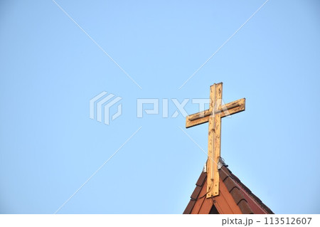 cross on rooftop of Christian church in sky background cross on rooftop of Christian church in sky background 113512607