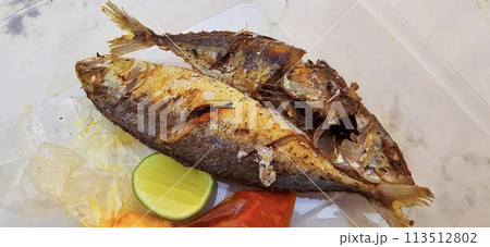 Fried Mackerel served with separate chili sauce and lime, or called Ikan kembung goreng. ikan banyar goreng  113512802