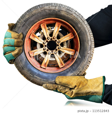Gloved Hands Holding a Wheel with Tire Isolated on White Background - Generative Ai 113512843