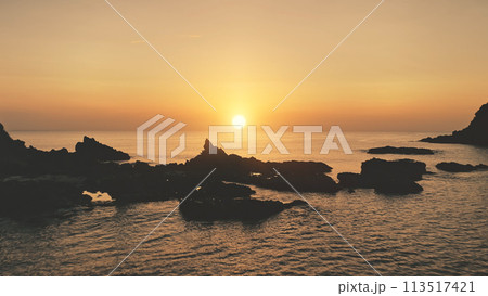 Mountain silhouette at sunset seascape aerial. Rocks of tropic island at ocean bay. Summer paradise 113517421