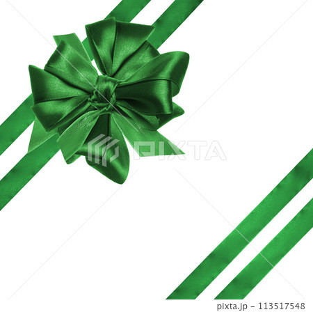 Tied bow made of green silk ribbon on an isolated background, decor for a gift. 113517548