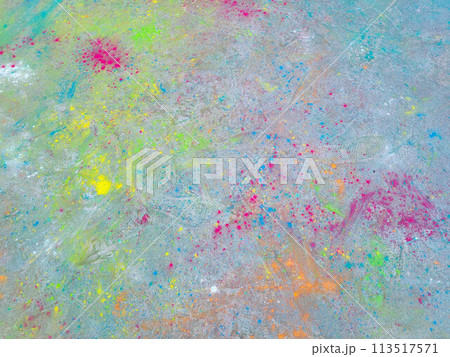 After the celebration of Holi, scattered paints on the asphalt 113517571