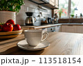 An inviting cup of coffee sits gracefully on top of a wooden table, creating a serene morning scene. 113518154