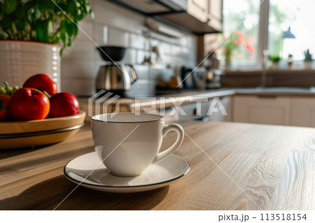 An inviting cup of coffee sits gracefully on top of a wooden table, creating a serene morning scene. 113518154