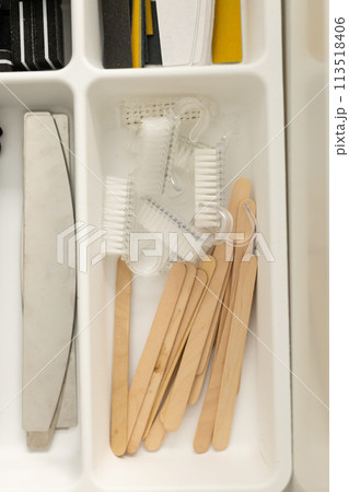 Manicure and pedicure tools. Nail file and cuticle pusher orange wood sticks. Top view 113518406
