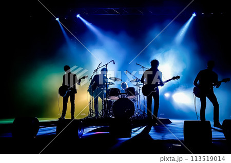 A band of four musicians playing on stage with a purple A band of four musicians playing on stage with a purple 113519014