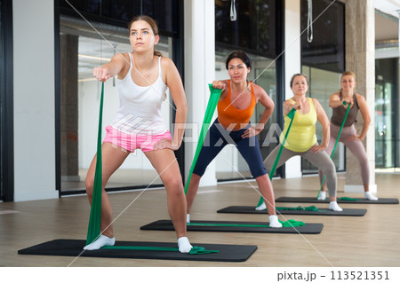 Women doing stretches with resistance bands Women doing stretches with resistance bands 113521351
