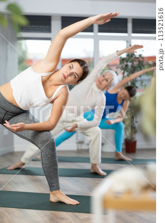 Young woman practicing pilates exercises in yoga studio Young woman practicing pilates exercises in yoga studio 113521616