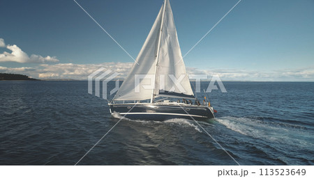 Slow motion closeup of sail luxury yacht at ocean bay aerial. Sailboat regatta race at open sea 113523649