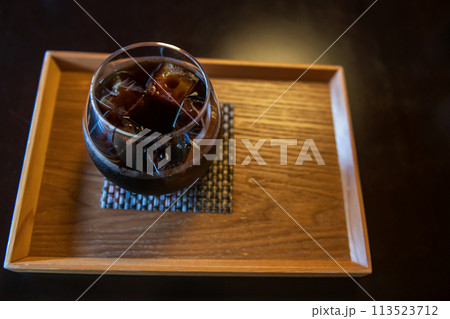 Ice Americano black coffee on wooden table by top view 113523712