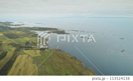 Alcohol industy at sea bay aerial. Whiskey distillery at countryside. Green forest, fields Alcohol industy at sea bay aerial. Whiskey distillery at countryside. Green forest, fields 113524138