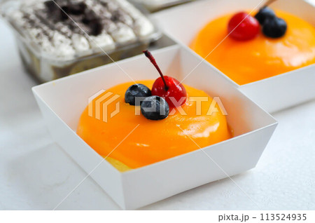 orange cake with cherry and blueberry topping or fruit cake or glaze cake 113524935