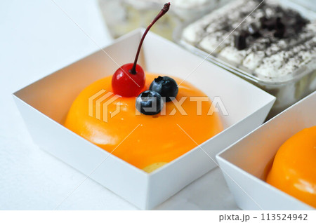 orange cake with cherry and blueberry topping or fruit cake or glaze cake 113524942