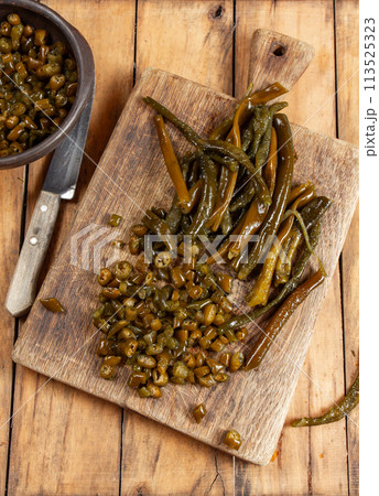 Chilean Australin peruvian seaweed COCHAYUYO. Choped cooked cochayuyo on board and boul Chilean Australin peruvian seaweed COCHAYUYO. Choped cooked cochayuyo on board and boul 113525323