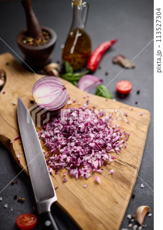 Chopped red Mars Onion on wooden cutting board at domestic kitchen 113527304