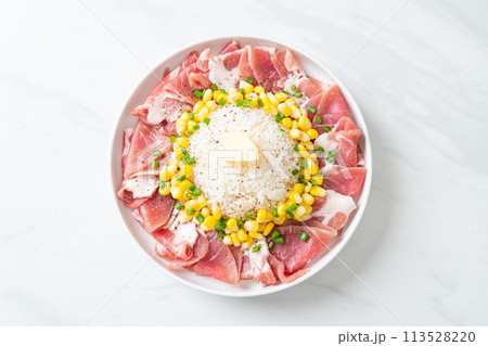 fresh pork raw sliced with rice and corn on plate and ready to cook 113528220
