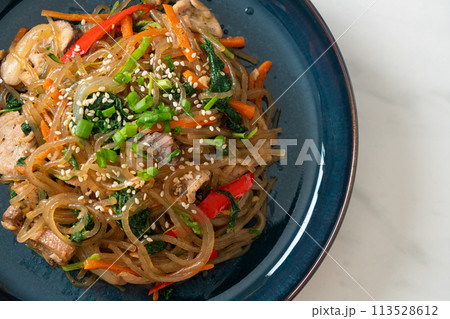 japchae or stir-fried Korean vermicelli noodles with vegetables and pork topped with white sesame japchae or stir-fried Korean vermicelli noodles with vegetables and pork topped with white sesame 113528612