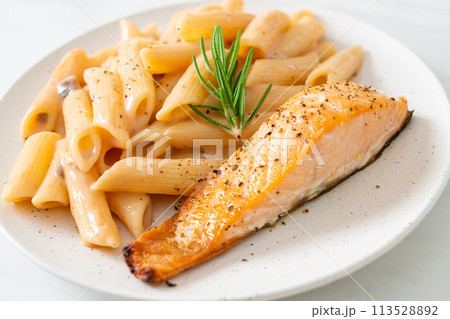 salmon with penne pasta cream sauce 113528892