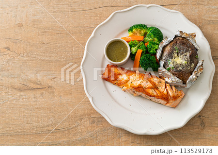grilled salmon steak with bake potato 113529178