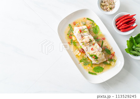 steamed sea bass fish with herbs 113529245