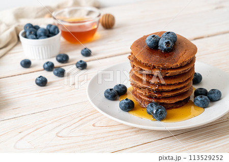 chocolate pancake stack with blueberry and honey 113529252