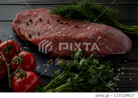 Raw beef steak with spices on a dark slate, stoneselective focus Raw beef steak with spices on a dark slate, stoneselective focus 113529617