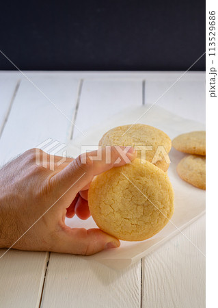 A sugar cookie in a man's hand 113529686