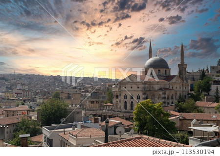 Gaziantep, Turkey - 16.10.2022: Gaziantep city skyline with Kurtulus mosque during sunset. Gaziantep, Turkey - 16.10.2022: Gaziantep city skyline with Kurtulus mosque during sunset. 113530194