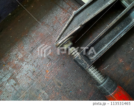 Clamp compression tool on the wooden background Clamp compression tool on the wooden background 113531465