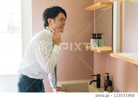 洗面所で歯を磨く若いアジア人男性(知覚過敏・歯周病・虫歯・しみる) 洗面所で歯を磨く若いアジア人男性(知覚過敏・歯周病・虫歯・しみる) 113531908