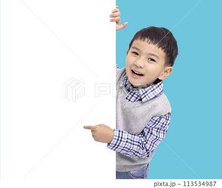 Happy Asian boy holding and pointing white empty banner Happy Asian boy holding and pointing white empty banner 113534987