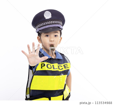 child dressed as a police officer standing and showing stop sign 113534988