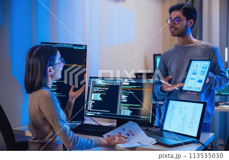 asian and Indian Developer  devops team discussion  about coding promgram with software computer at night in office 113535030