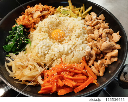 Bibimbap dish of meat, rice, vegetables and egg 113536633