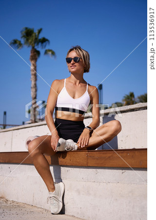 Portrait of caucasian young woman in sporty outfit relaxing meditating feeling zen-like on fitness 113536917